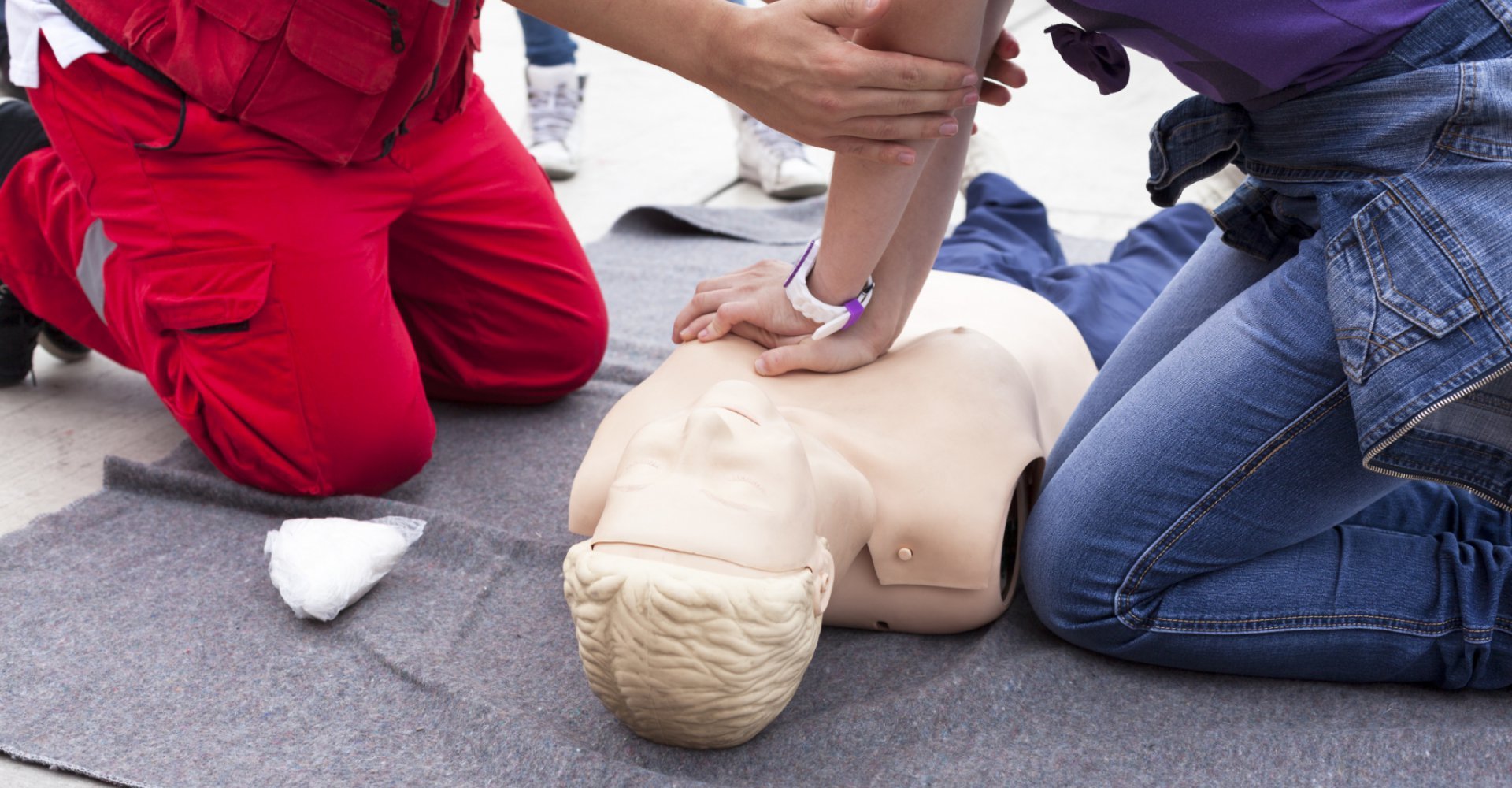 first aid trainer resuscitating mannequin